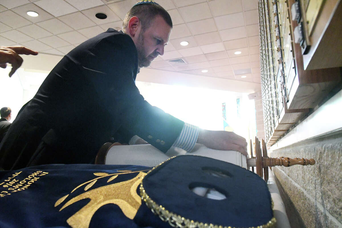 Ezra Konigsberg, Ritual Director at Temple Sholom, rolls the Temple's new Sefer Torah as he prepares it for a formal dedication ceremony in Greenwich, Conn., June 9, 2016. The Torah was written by a scribe in Israel but congregants were able to contribute to the writing through scheduled appointments over the course of the past year it took to write. The new scroll is lighter than the others in the collection, making it suitable for bar and bat mitvah ceremonies. This is the first time a new Torah has been added to the Temple's collection since the early 1990s.