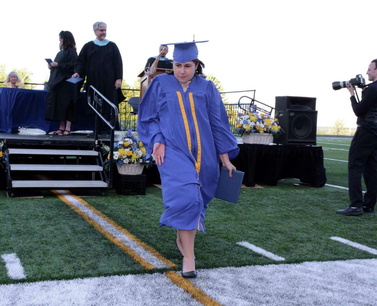 Jillian Murphy dances her way back to her seat after receiving her diploma during Seymour High School's Commencement ceremony on their campus in Seymour, Conn.. The graduation was held on Thursday June, 9, 2016.