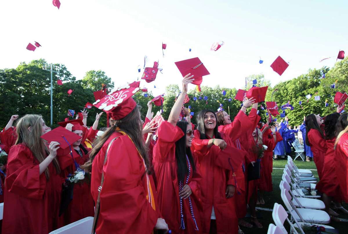 Graduates toss their caps at the Joseph A. Foran High School graduation ceremony in Milford, Conn. on Thursday, June 9, 2016.