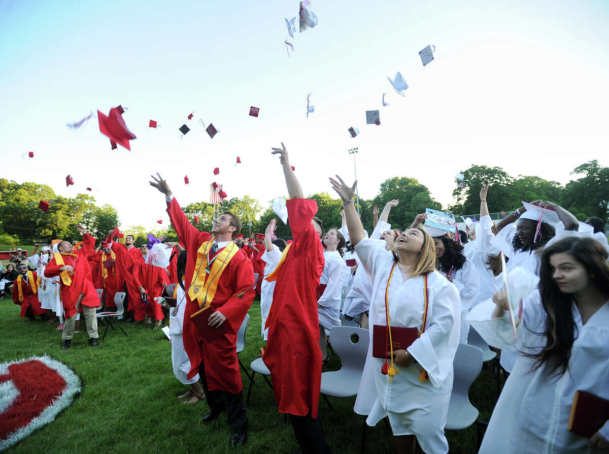 Graduates throw their caps into the air after receiving their diplomas at the Derby High School graduation ceremony Thursday at Leo F. Ryan Athletic Complex.