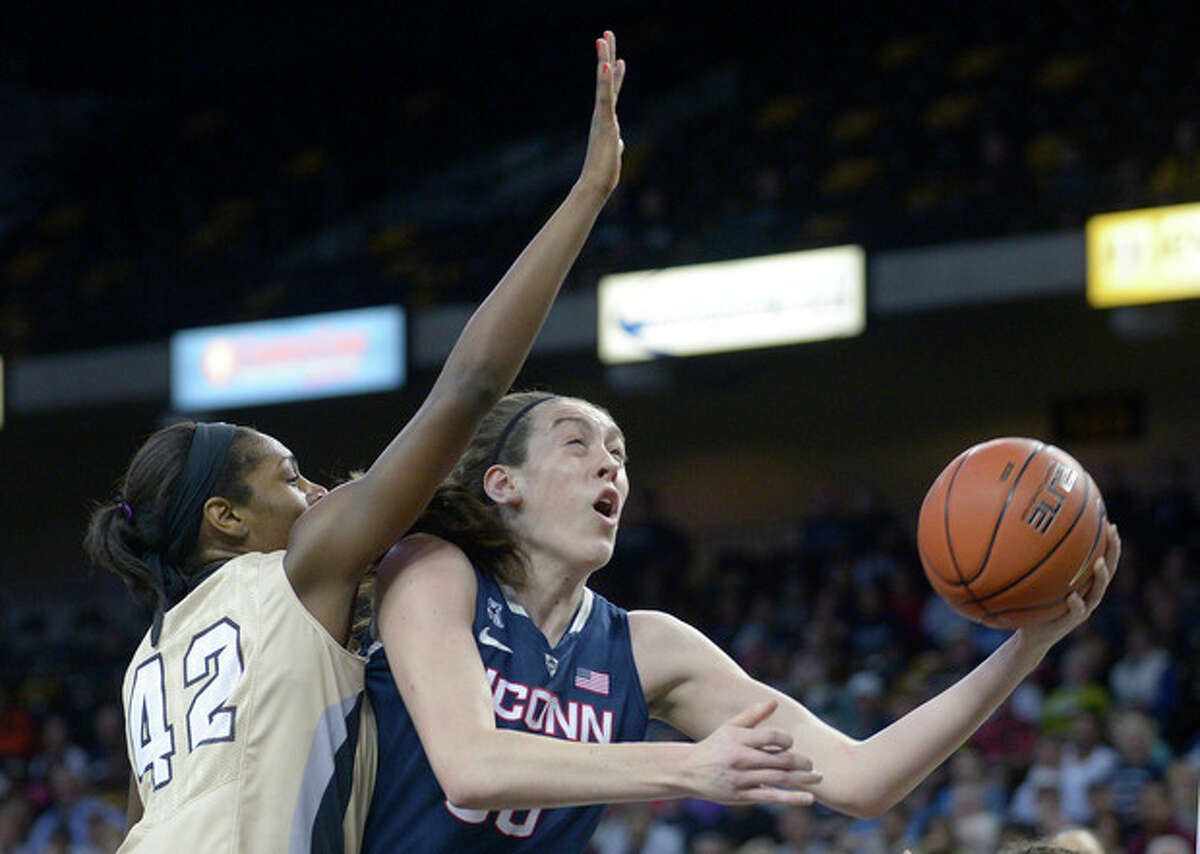 Connecticut forward Breanna Stewart, right, goes up for a shot in front of Central Florida forward Stephanie Taylor (42) during the first half of an NCAA college basketball game in Orlando, Fla., Wednesday, Jan. 1, 2014. (AP Photo/Phelan M. Ebenhack)