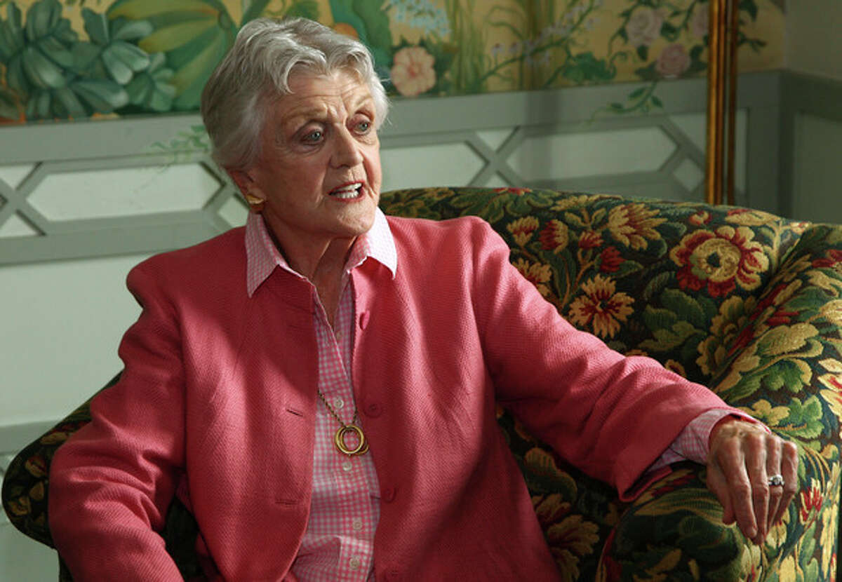 FILE - In this Jan. 7, 2013 file photo, actress Angela Lansbury poses for photos in Sydney, Australia. Lansbury the 88-year-old actress was one of more than 1,000 people who were recognized by Britain's Queen Elizabeth II in the New Years Honors List. For the first time since the Order of the British Empire was founded in 1917, most of them were women. (AP Photo/Rick Rycroft, File)