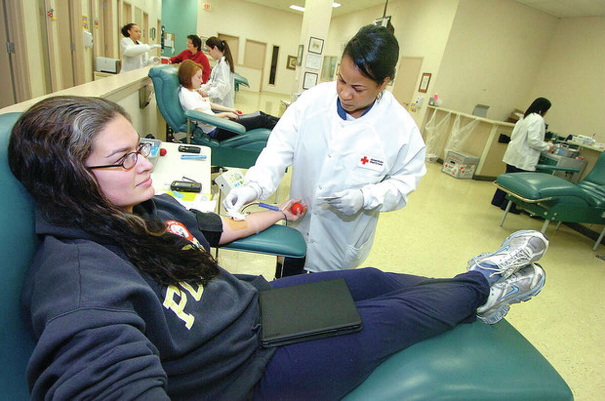 Hour file photo / Alex von Kleydorff At the American Red Cross on Westport Avenue, Weston's Marta Taddeo gives a pint of blood with help from Phlebotomist Troy Smith.
