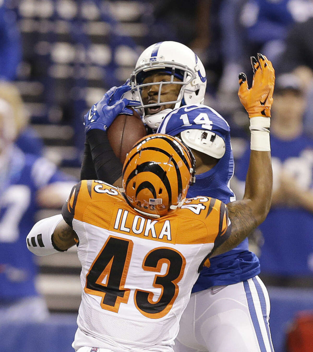 Indianapolis Colts' Hakeem Nicks (14) makes a catch against Cincinnati Bengals' George Iloka (43) during the first half of an NFL wildcard playoff football game, Sunday, Jan. 4, 2015, in Indianapolis. (AP Photo/Michael Conroy)