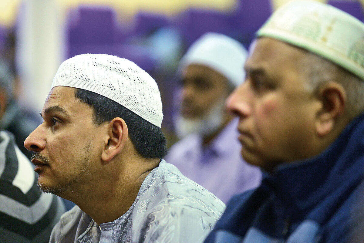 Hour photo / Erik Trautmann Muslims worship at the new home of the Al Madany mosque on Park St in Norwalk Friday.
