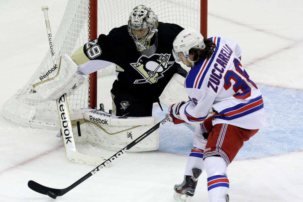 New York Rangers' Mats Zuccarello (36) cannot get a shot off in front of Pittsburgh Penguins goalie Marc-Andre Fleury (29) in the first period of an NHL hockey game in Pittsburgh, Friday, Jan. 3, 2014. (AP Photo/Gene J. Puskar)
