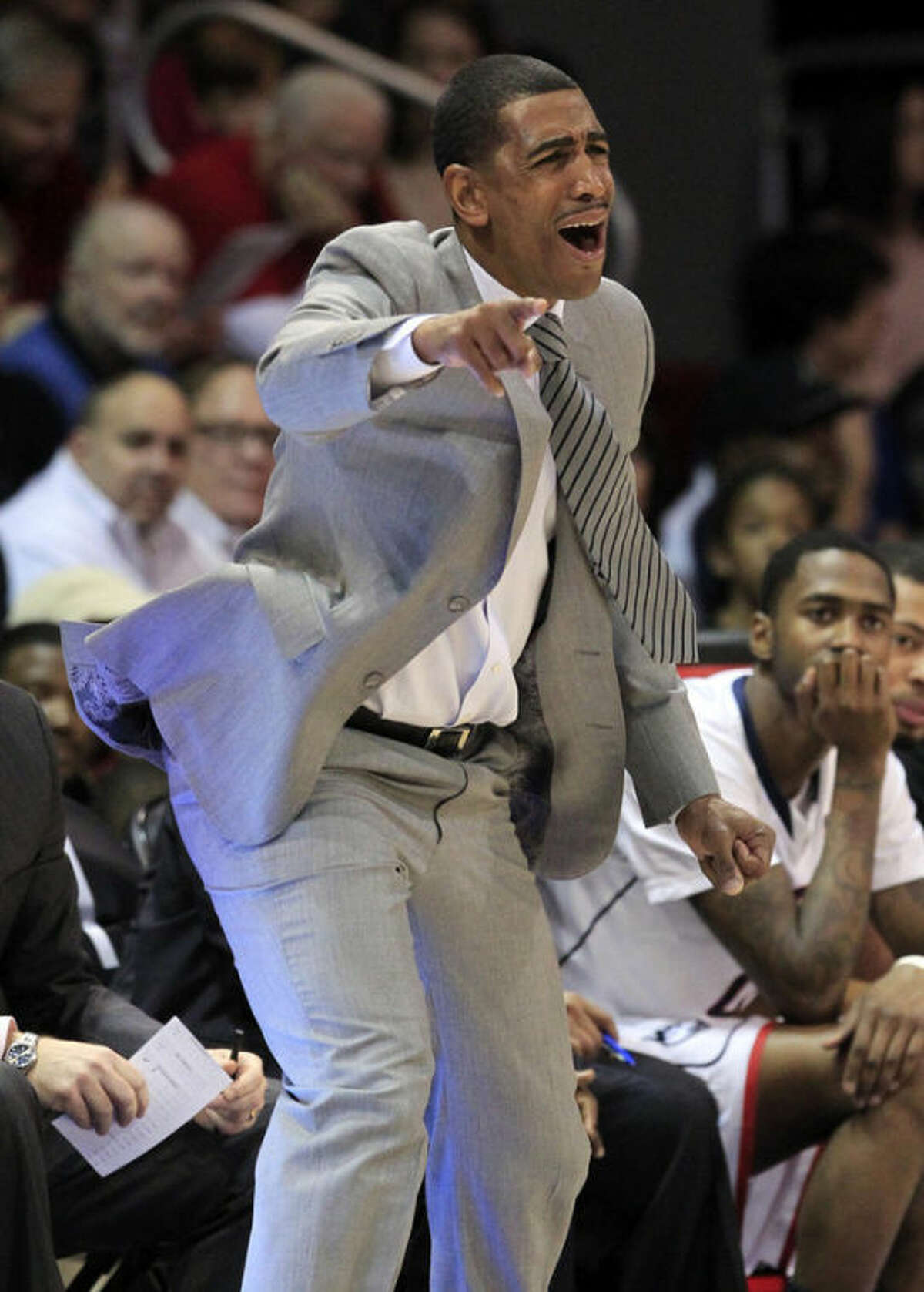 Connecticut head coach Kevin Ollie signals instructions to his team during the first half of a NCAA basketball game against SMU, Saturday, Jan. 4, 2014, in Dallas.  (AP Photo/John F. Rhodes)