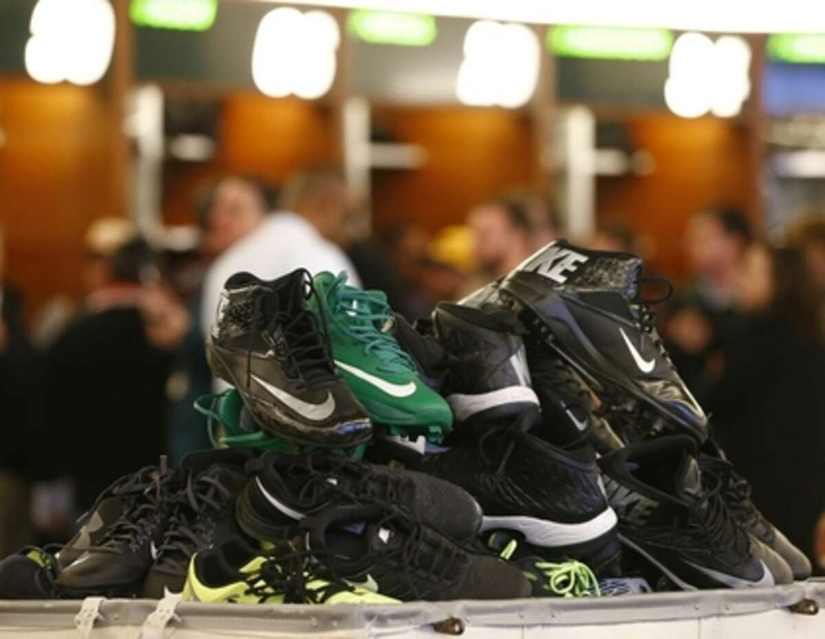 A stack of cleats are piled up in the locker room as New York Jets talk to the media and clear out their lockers at the team's NFL football training facility, Monday, Jan.4, 2016, in Florham Park, N.J. (AP Photo/Rich Schultz)