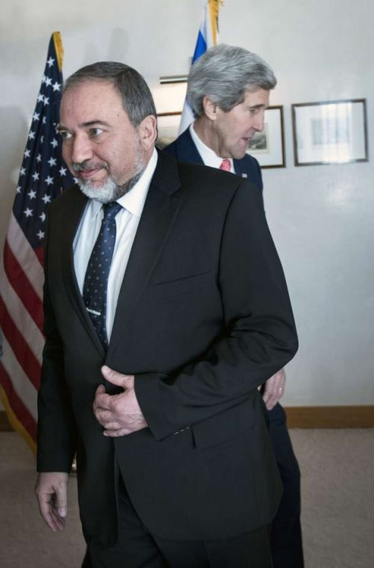 Israeli Foreign Minister Avigdor Lieberman, walks in front of U.S. Secretary of State John Kerry, ahead of their meeting at the David Citadel hotel in Jerusalem, Friday, Jan. 3, 2013. (AP Photo/Brendan Smialowski, Pool)