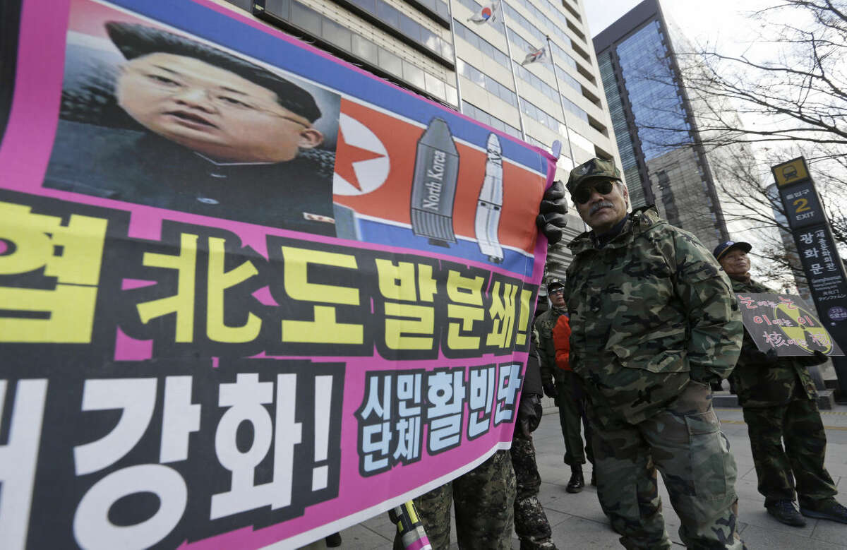 A banner shows a picture of North Korean leader Kim Jong Un as South Korean war veterans stage a rally against North Korea in Seoul, South Korea, Saturday, Jan. 9, 2016. North Korea trumpets a hydrogen bomb test. South Korea responds by cranking up blasts of harsh propaganda from giant green speakers aimed across the world’s most dangerous border. The letters at a banner read "Smash the North Korean provocation which threatens peace of global village!" (AP Photo/Ahn Young-joon)