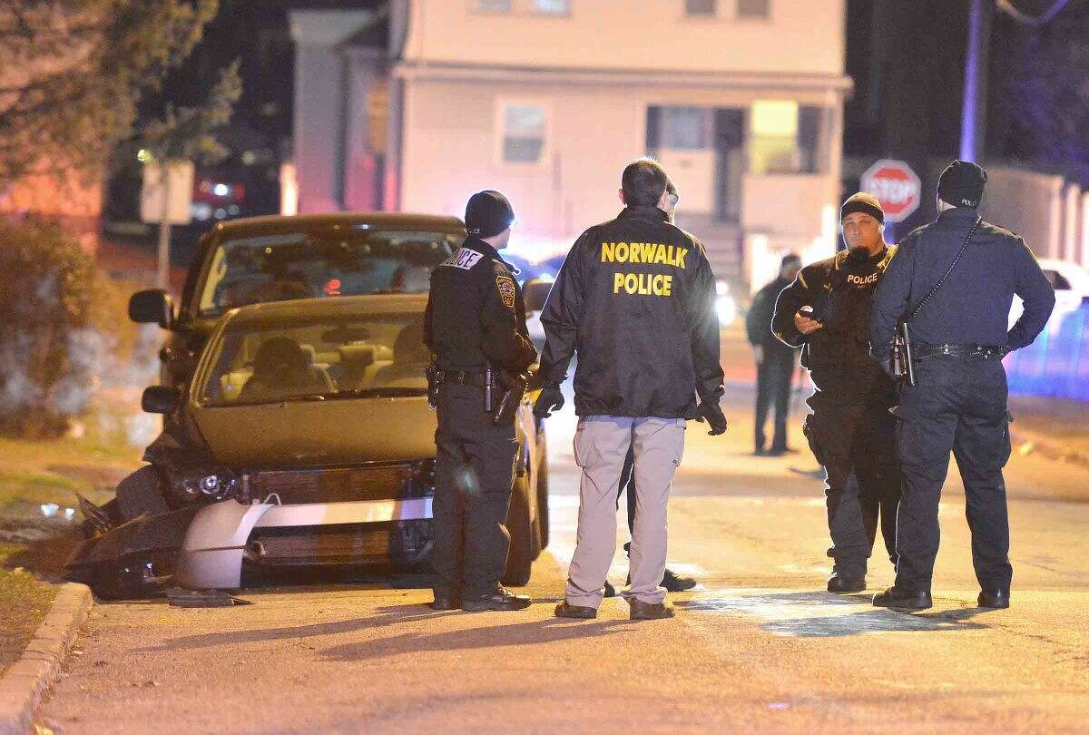Hour Photo/Alex von Kleydorff Norwalk Police investigate an area and a damaged vehicle on Sheridan St Friday night possibly connected to a shooting in the area