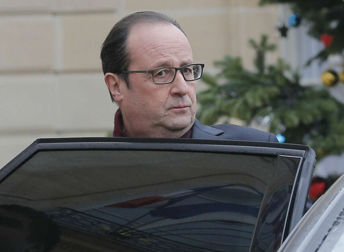 French President Francois Hollande leaves the Elysee Palace after a shooting at a French satirical newspaper, in Paris, France, Wednesday, Jan. 7, 2015. Police official says 11 dead in shooting at French satirical newspaper Charlie Hebdo. (AP Photo/Christophe Ena)