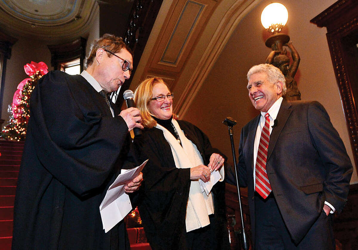 Hour photo / Erik Trautmann Norwalk Judge of Probate Antony DePanfilis gets sworn in for his last 4 year term by Superior Court Judges Eddie Rodriguez and Maureen Dennis during a ceremony at Lockwood Mathews Mansion Wednesday morning.