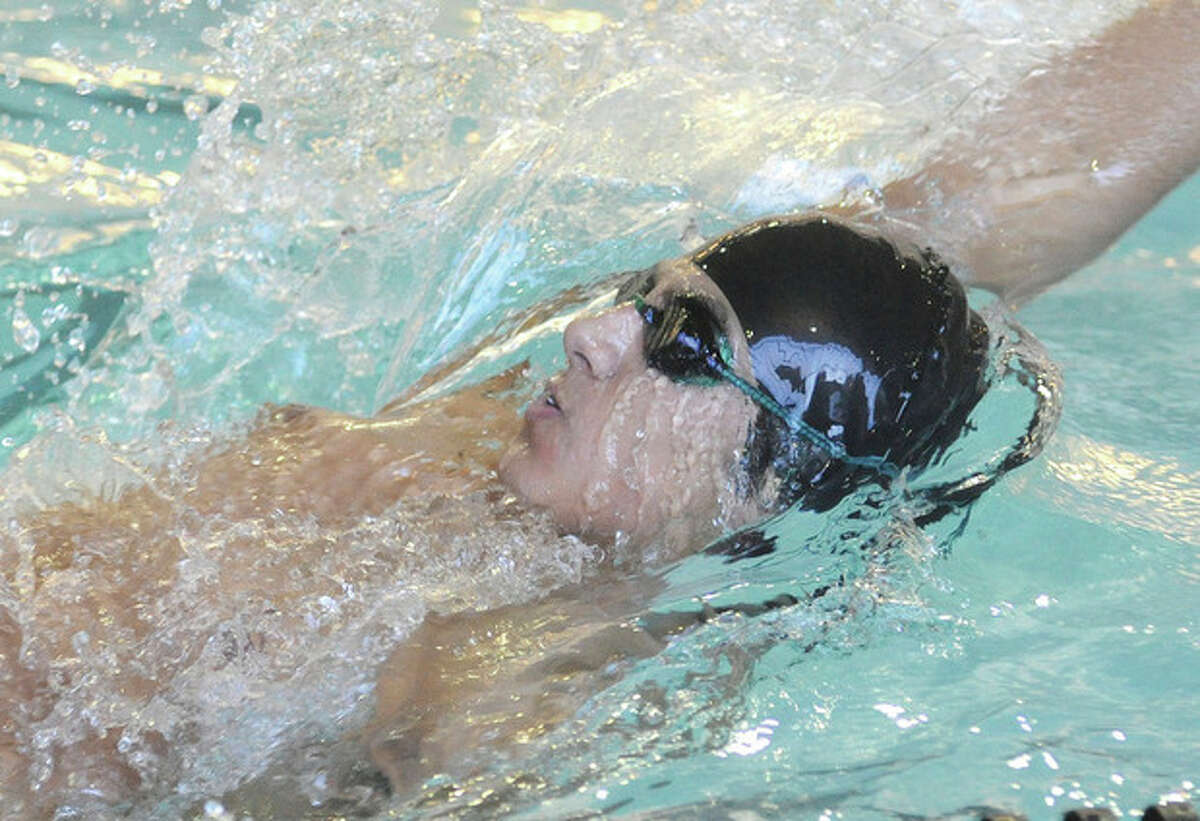 Hour photo/Matthew Vinci Nico Roldan of the Norwalk-McMahon co-op swim team competes in the 200 individual medley during Tuesday's meet against Fairfield Warde at NHS. Roldan won the 100 backstroke and shared in Norwalk's win in the 400 frestyle relay.