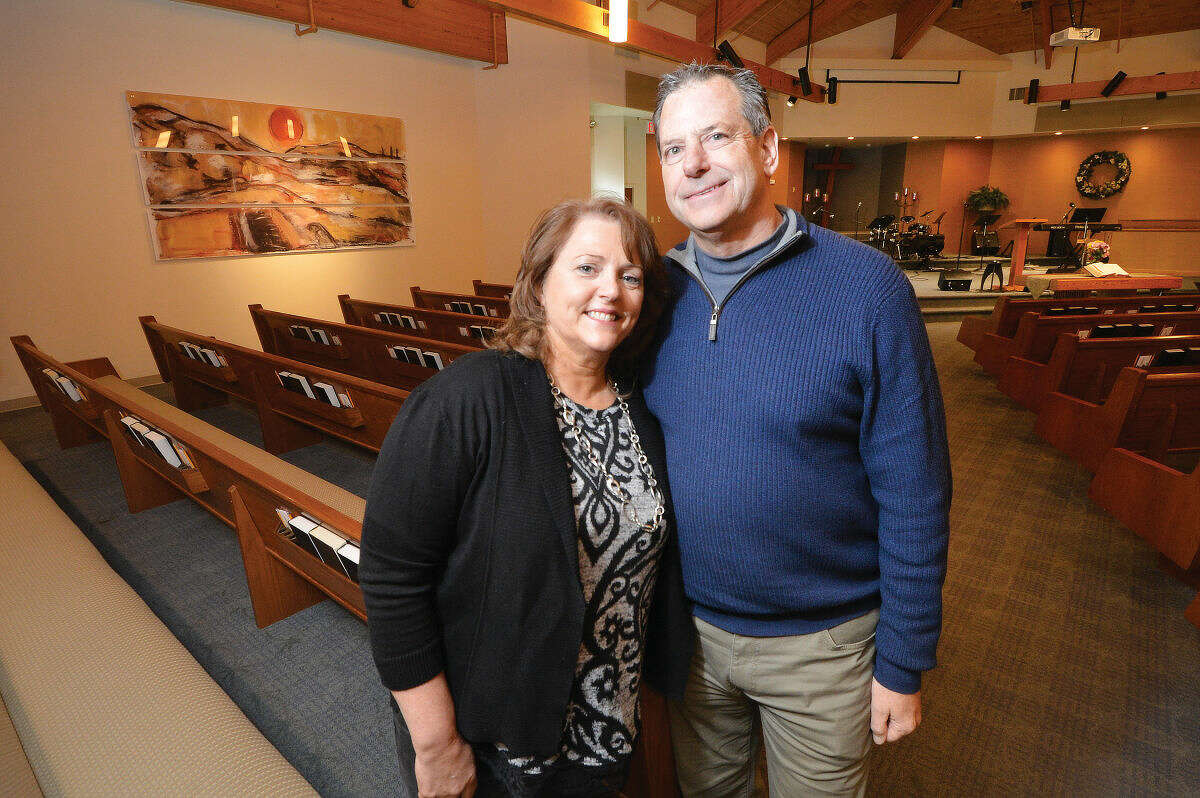 Author Jennifer Gish and her husband, Pastor Dave Gish, pose for a photo inside the sanctuary at Hope Church in Wilton.