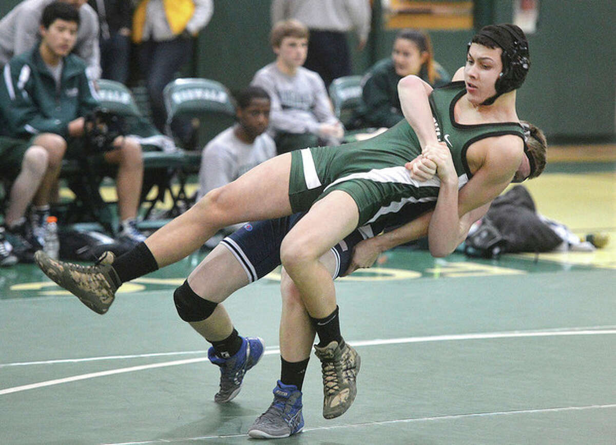 Hour photo/Alex von Kleydorff Norwalk's Kevin Garcia (in green) and Harry Winrow of Wilton battle it out in the 138-pound class during Wednesday's action at Norwalk High. Winrow won by tech fall, and the visiting Warriors downed the Bears, 54-24.