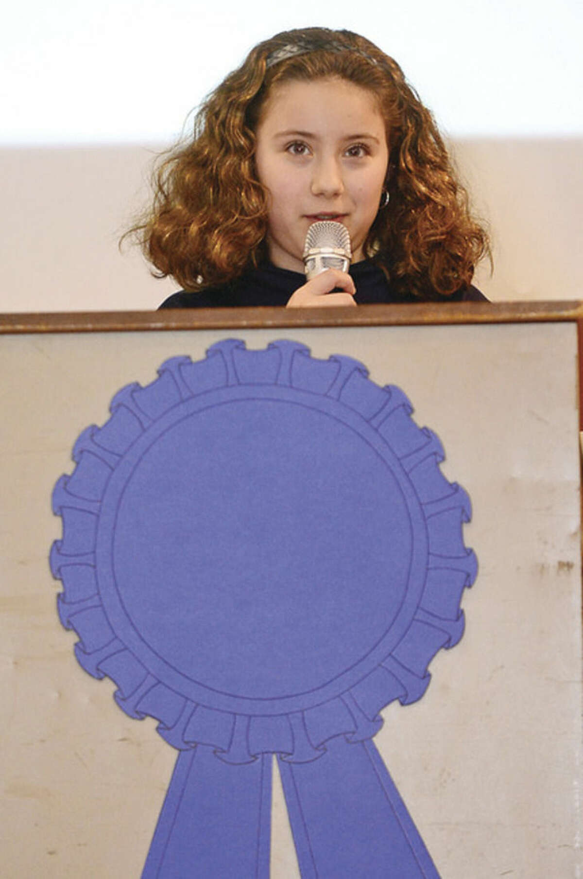 Hour photo / Erik Trautmann Jefferson Science Magnet School 5th grader Kaitlyn Giancaspro sepaks to students, faculty and guests as the school celebrates the National Blue Ribbon Award they received for closing the achievement gap between student sub-groups during a ceremony Tuesday morning.
