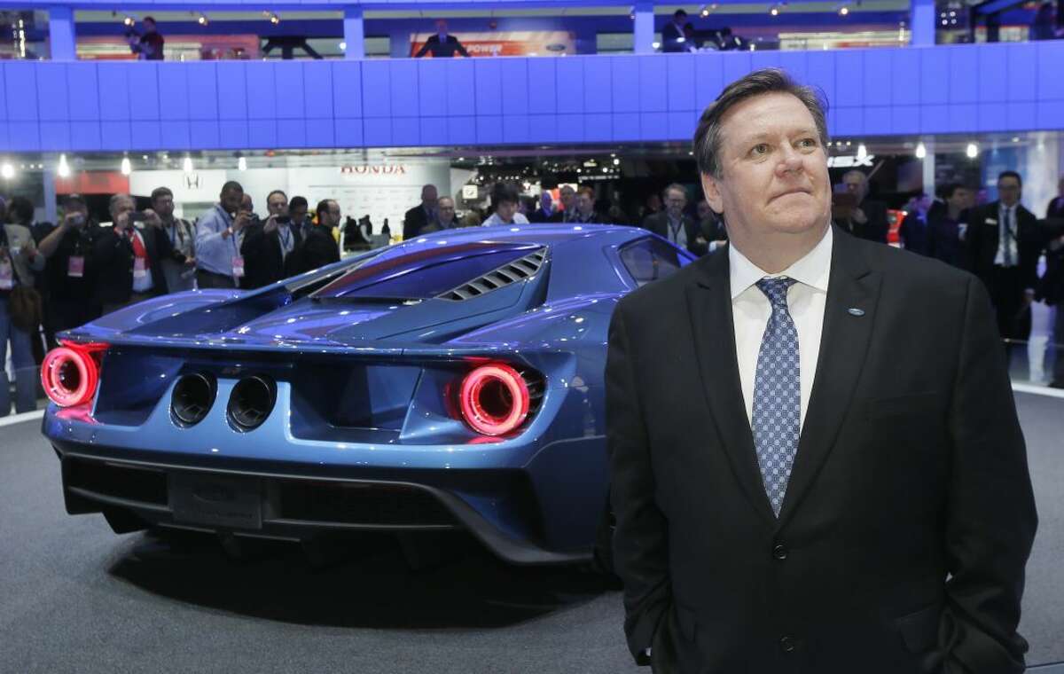 Ford Motor Co., Vice President of Design Moray Callum stands next to the automaker's new GT on the floor of the North American International Auto Show, Monday, Jan. 12, 2015 in Detroit. (AP Photo/Carlos Osorio)