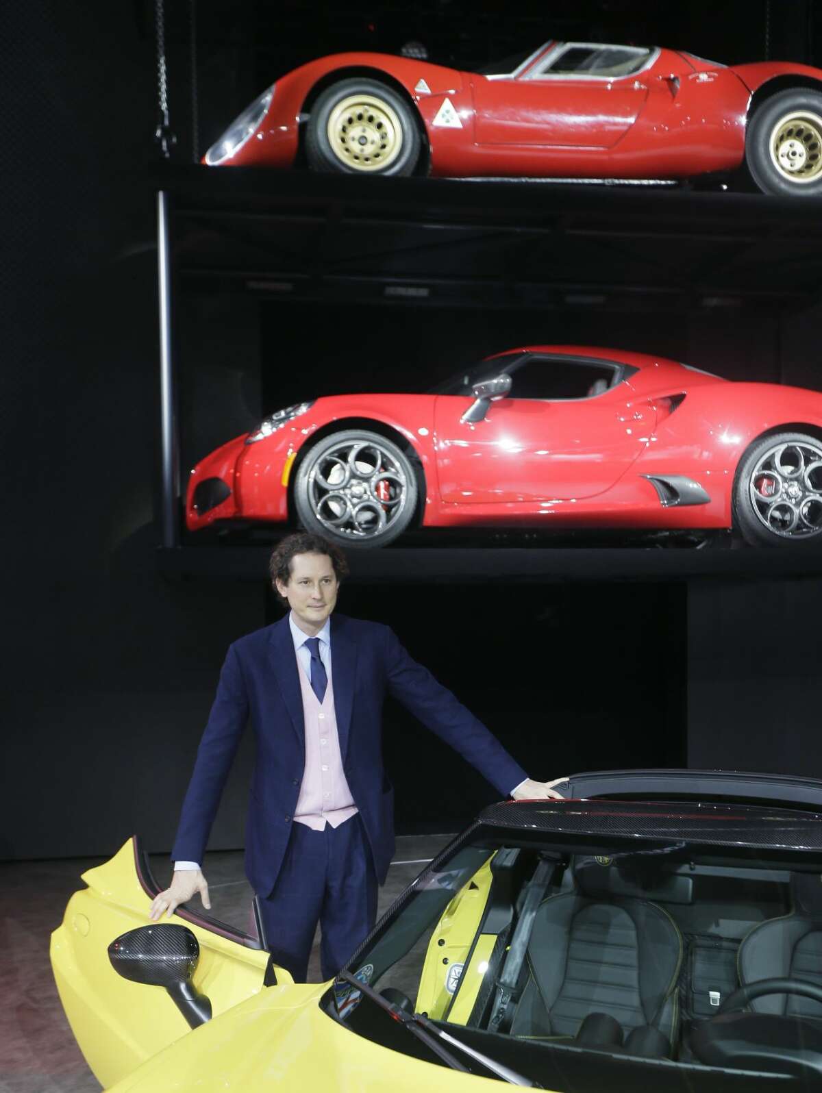 Chairman of Fiat Chrysler Automobiles John Elkann stands by the Alfa Romeo 4C Spider during the North American International Auto Show, Monday, Jan. 12, 2015 in Detroit. (AP Photo/Carlos Osorio)
