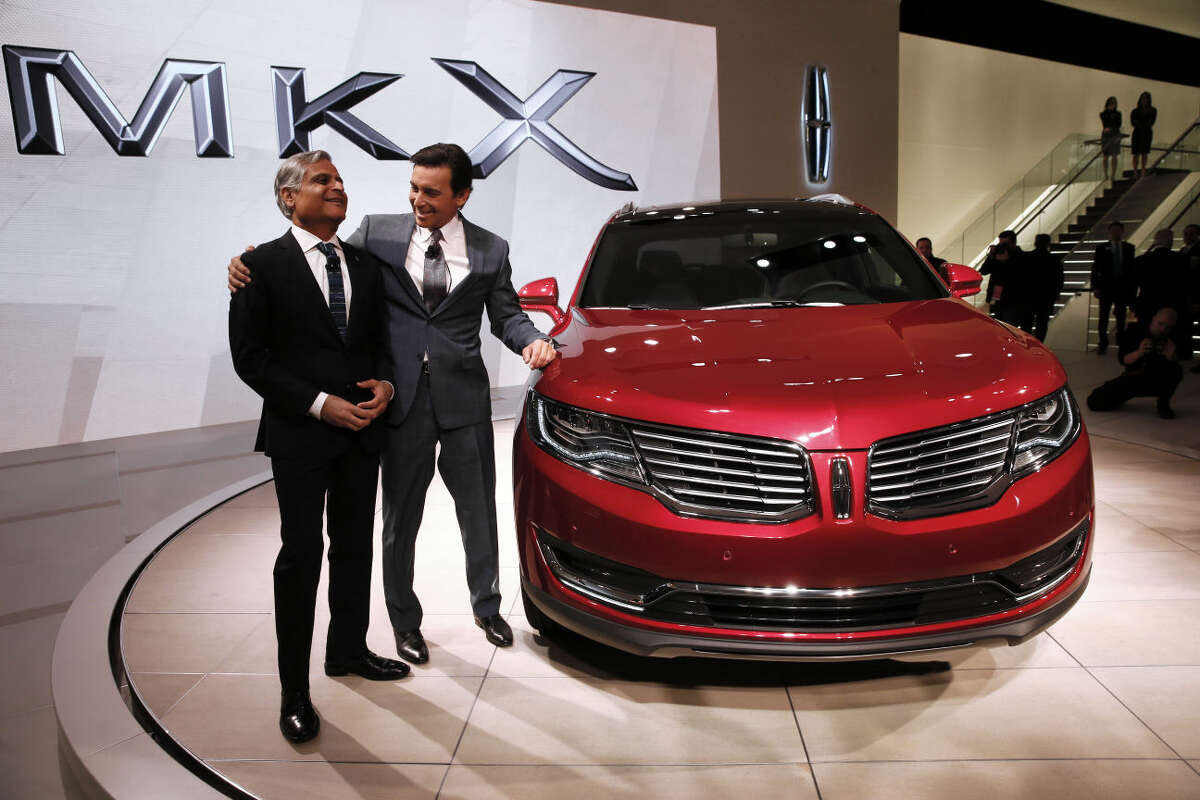 Kumar Galhotra, President of Lincoln, left, and Mark Fields, President and CEO, Ford Motor Company, pose with the Lincoln MKX during media previews for the North American International Auto Show in Detroit, Tuesday, Jan. 13, 2015. (AP Photo/Paul Sancya)