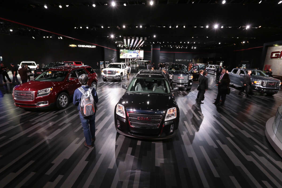 People walk through the GMC area during the 2015 North American International Auto Show, Tuesday, Jan. 13, 2015 in Detroit. (AP Photo/Detroit Free Press, Ryan Garza) DETROIT NEWS OUT; NO SALES