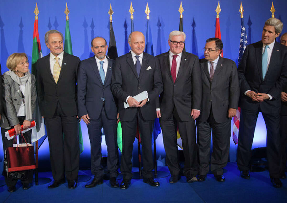 From left, Italian Foreign Minister Emma Bonino, Saudi Foreign Minister Prince Saud al-Faisal, Syrian National Coalition Chief Ahmad al-Jarba, French Foreign Minister Laurent Fabius, German Foreign Minister Frank-Walter Steinmeier, Egyptian Foreign Minister Nabil Fahmy, US Secretary of State John Kerry, pose for a group photo prior to a joint press conference at the foreign ministry in Paris, Sunday, Jan. 12, 2014. The head of Syria?’s main Western-backed opposition group says its international supporters agree that Bashar Assad has no future as the country?’s leader. The statement Sunday from Ahmad al-Jarba comes as U.S. Secretary of State John Kerry and top envoys from 10 other countries raised the pressure for peace talks that would bring his Syrian National Coalition face-to-face with the government the rebels are trying to overthrow. (AP Photo/Michel Euler)