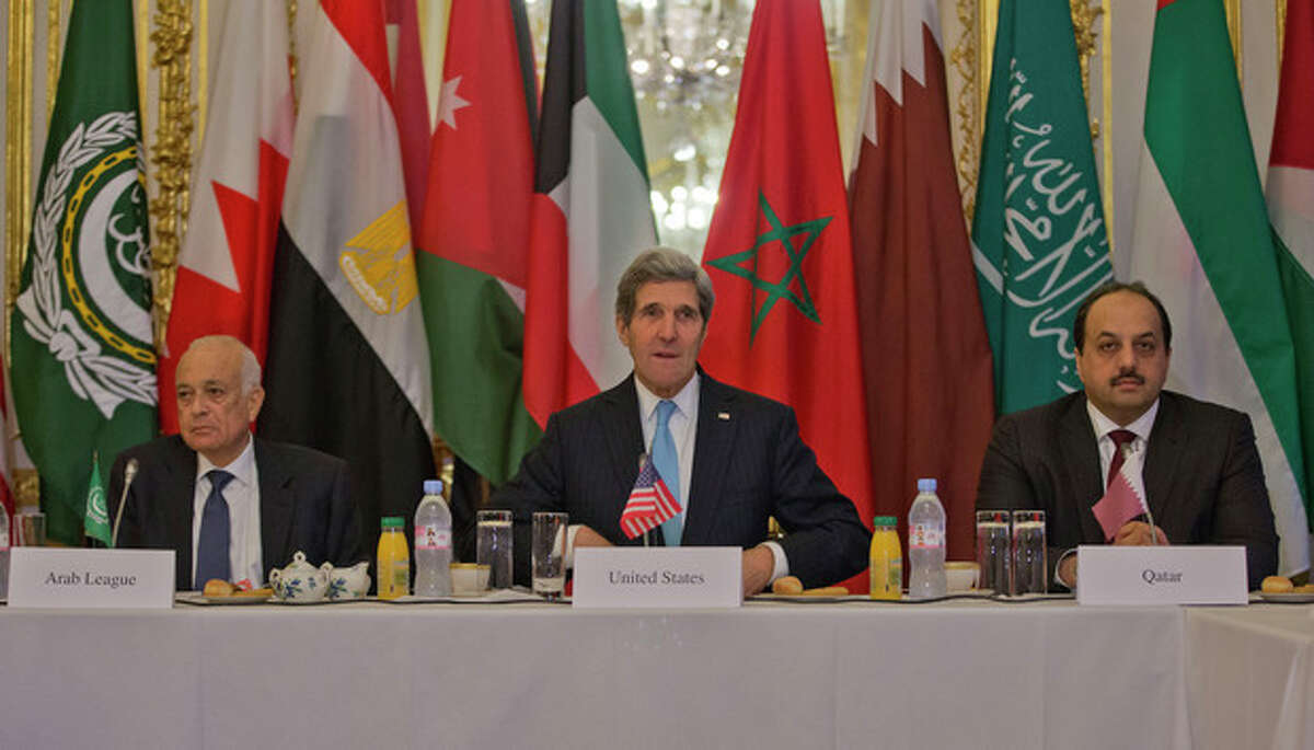 US Secretary of State, John Kerry, center, with Arab League Secretary General Nabil Elaraby, left, and Qatar's Foreign Minister Khalid bin Mohamed Al-Attiyah, right, before the start of a meeting with representatives of the Arab League at the US Ambassador's residence in Paris, France, Sunday, Jan. 12, 2014. Kerry is in Paris to attend a two-day meeting on Syria to rally international support for ending the three-year civil war. (AP Photo/Pablo Martinez Monsivais, Pool)