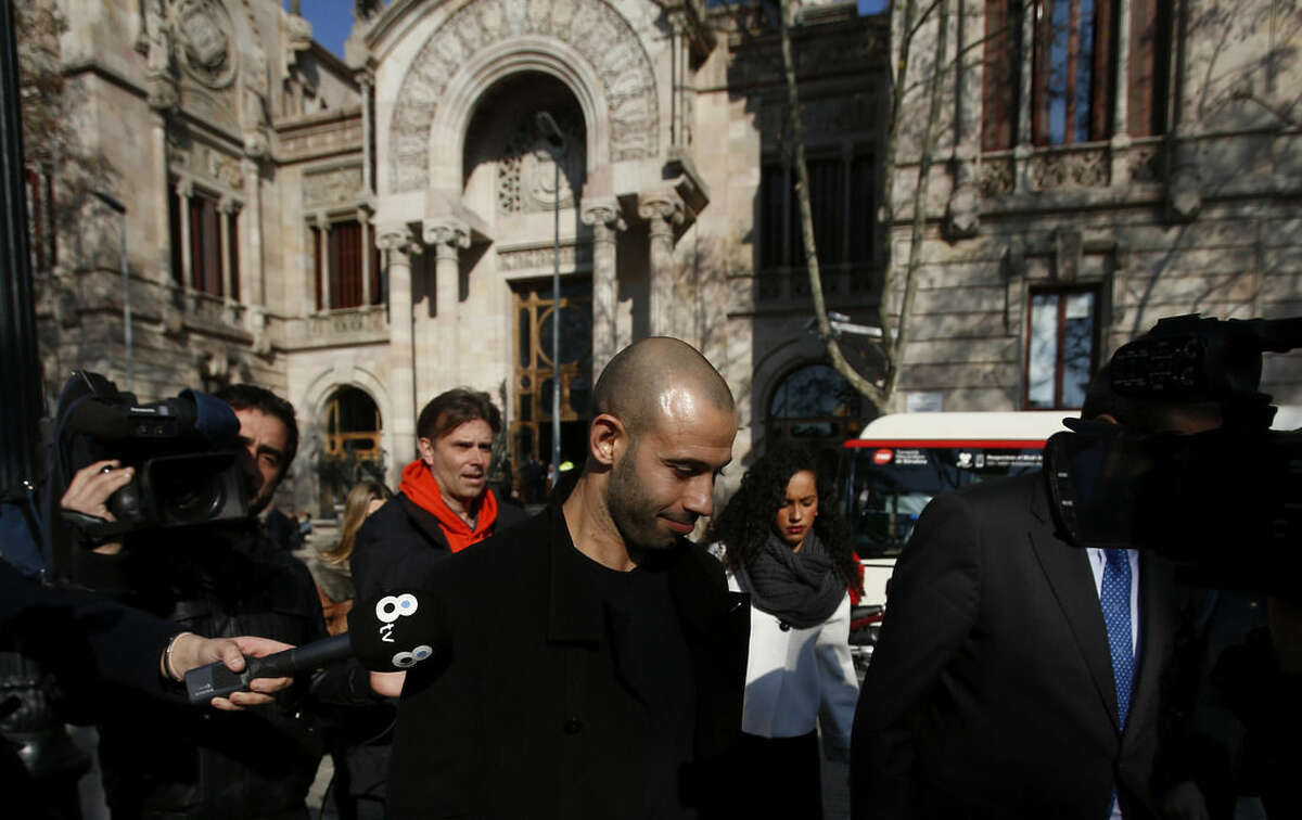 FC Barcelona defender Javier Mascherano, centre, from Argentina, leaves the court after answering questions in a tax fraud case in Barcelona, Spain, Thursday, Jan. 21, 2016. Mascherano has accepted a one-year prison sentence for not properly paying taxes in Spain but is not expected to face any jail time. The sentencing on Thursday came nearly three months after the Barcelona defender had reached a deal with prosecutors and the attorney’s office for failing to pay nearly 1.5 million euros ($1.6 million) in taxes for 2011 and 2012. (AP Photo/Manu Fernandez)