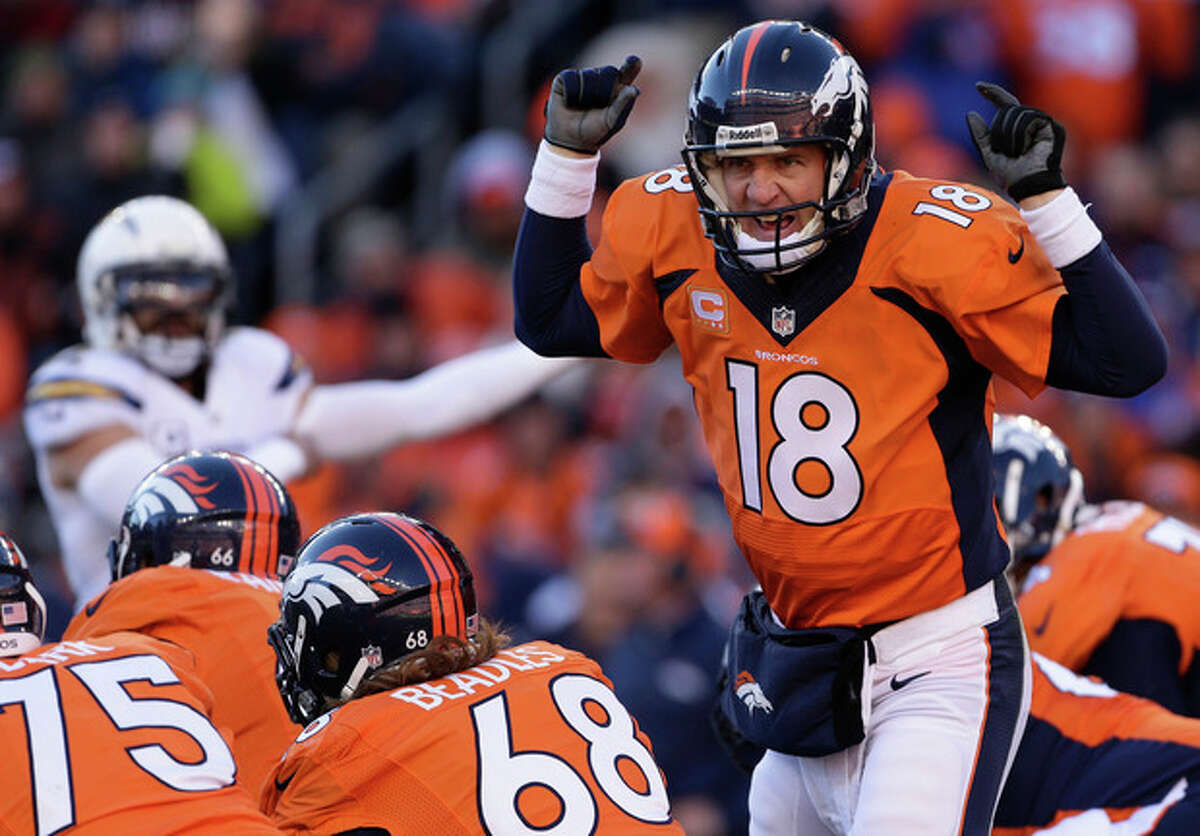 Denver Broncos quarterback Peyton Manning (18) calls an audible at the line of scrimmage against the San Diego Chargers in the first quarter of an NFL AFC division playoff football game, Sunday, Jan. 12, 2014, in Denver. (AP Photo/Charlie Riedel)