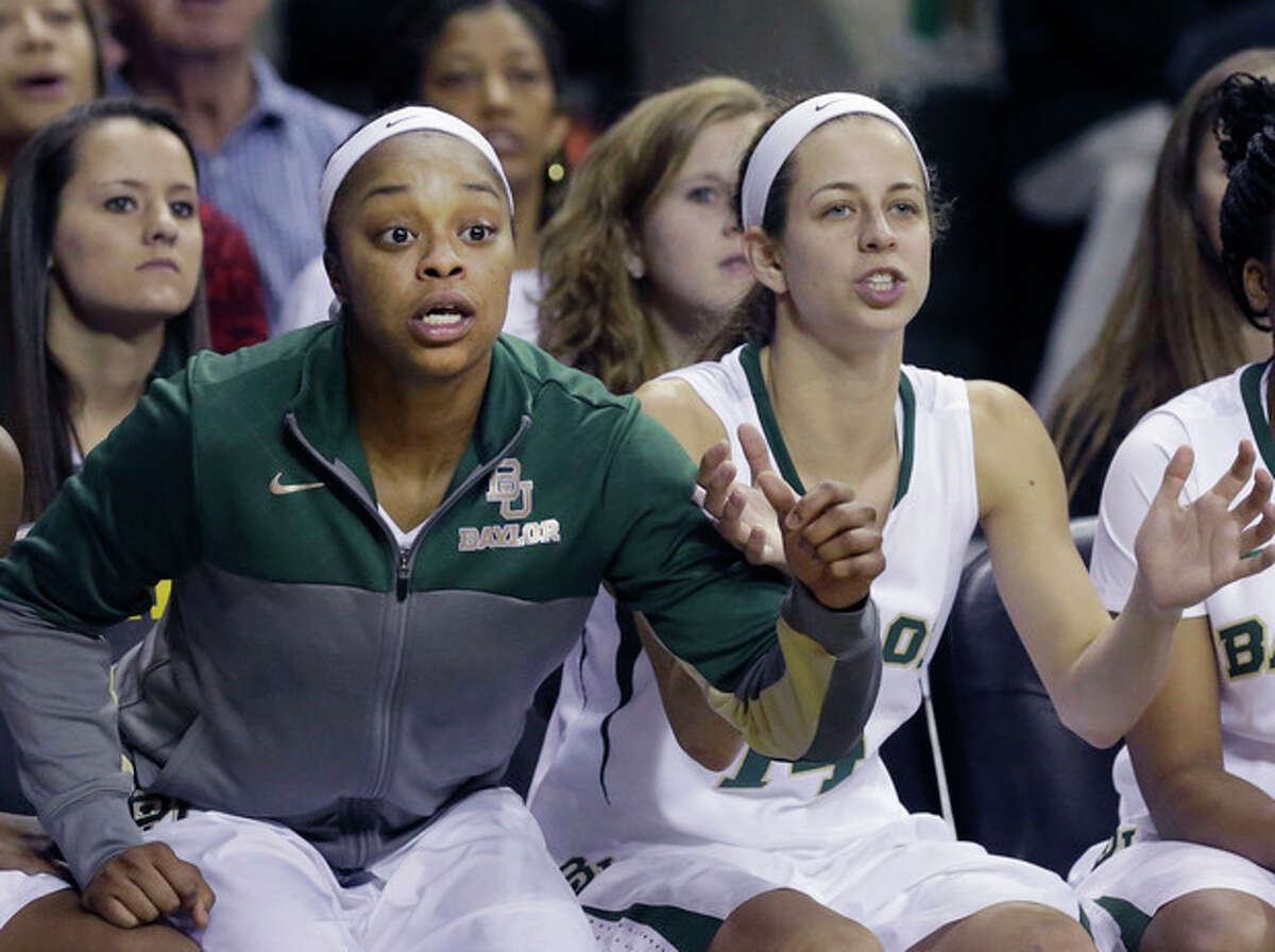 Baylor guard Odyssey Sims, left, and teammate Makenzie Robertson watch from the bench during the second half of an NCAA college basketball game against TCU, Saturday, Jan. 11, 2014, in Waco, Texas. Baylor won 80-46. (AP Photo/LM Otero)