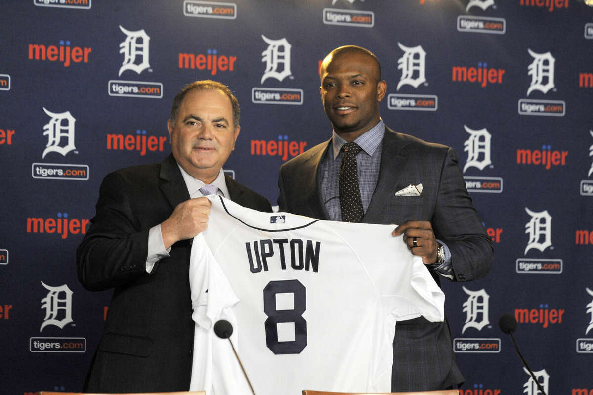 In this Jan. 20, 2016, photo, Detroit Tigers gewneral manager Al Avila, left, poses with new Tigers outfielder Justin Upton after announcing a six-year contract at Comerica Park in Detroit, Mich. (Steve Perez/Detroit News via AP) DETROIT FREE PRESS OUT; HUFFINGTON POST OUT; MANDATORY CREDIT
