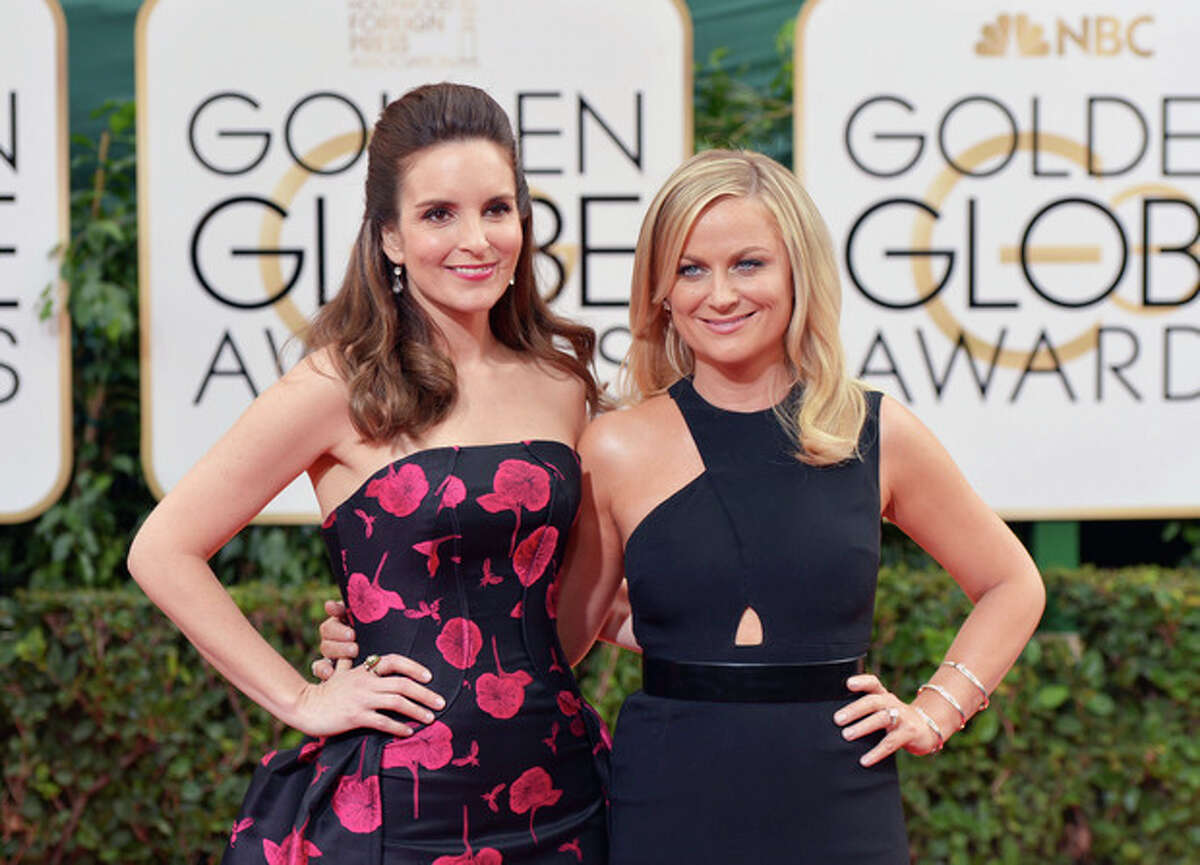 Tina Fey, left, and Amy Poehler arrive at the 71st annual Golden Globe Awards at the Beverly Hilton Hotel on Sunday, Jan. 12, 2014, in Beverly Hills, Calif. (Photo by John Shearer/Invision/AP)