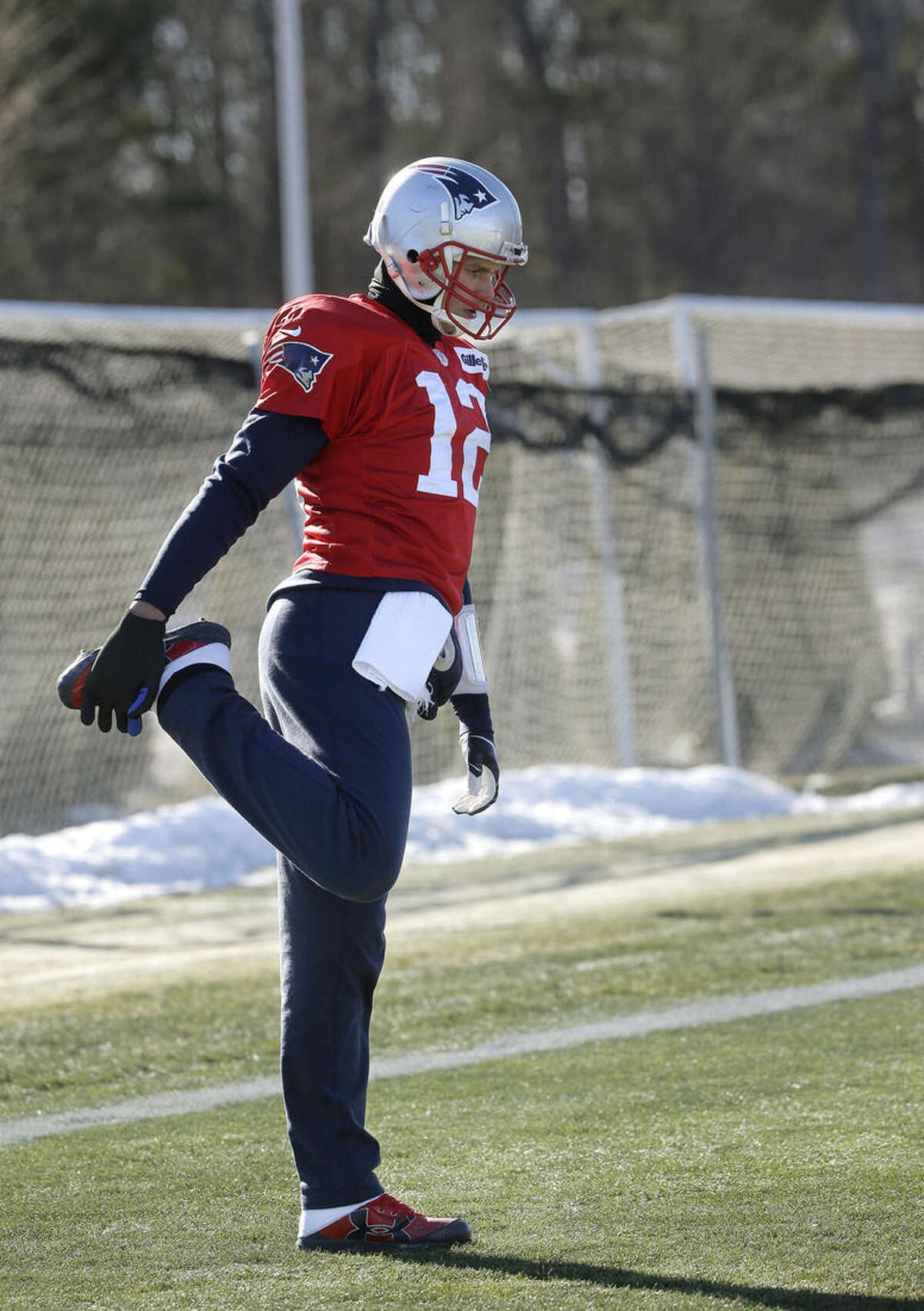 New England Patriots quarterback Tom Brady stretches while warming up during an NFL football practice, Thursday, Jan. 21, 2016, in Foxborough, Mass. The Patriots are to play the Denver Broncos in the AFC Championship on Sunday in Denver. (AP Photo/Steven Senne)