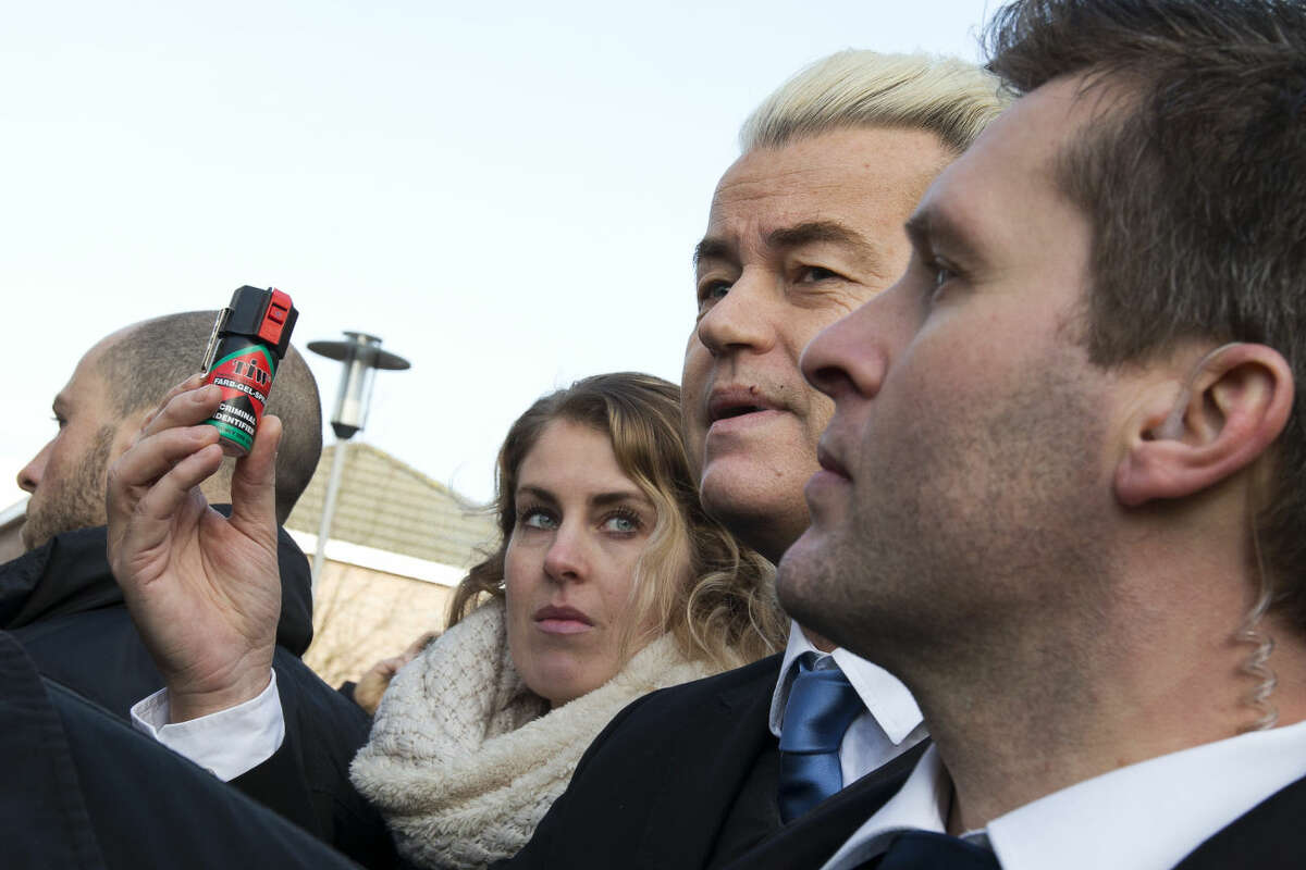 Firebrand Dutch lawmaker Geert Wilders holds a can of pepper spray prior to handing out "self-defense sprays" to women fearful of being attacked by migrants in the wake of the New Year's Eve sexual assaults in Cologne, in the center of Spijkenisse, near Rotterdam, Netherlands, Saturday, Jan. 23, 2016. Saturday’s event was a trademark headline-grabbing foray into the Dutch public by the leader of the Freedom Party. Such publicity stunts have landed him atop Dutch opinion polls a year away from parliamentary elections in the Netherlands. (AP Photo/Peter Dejong)