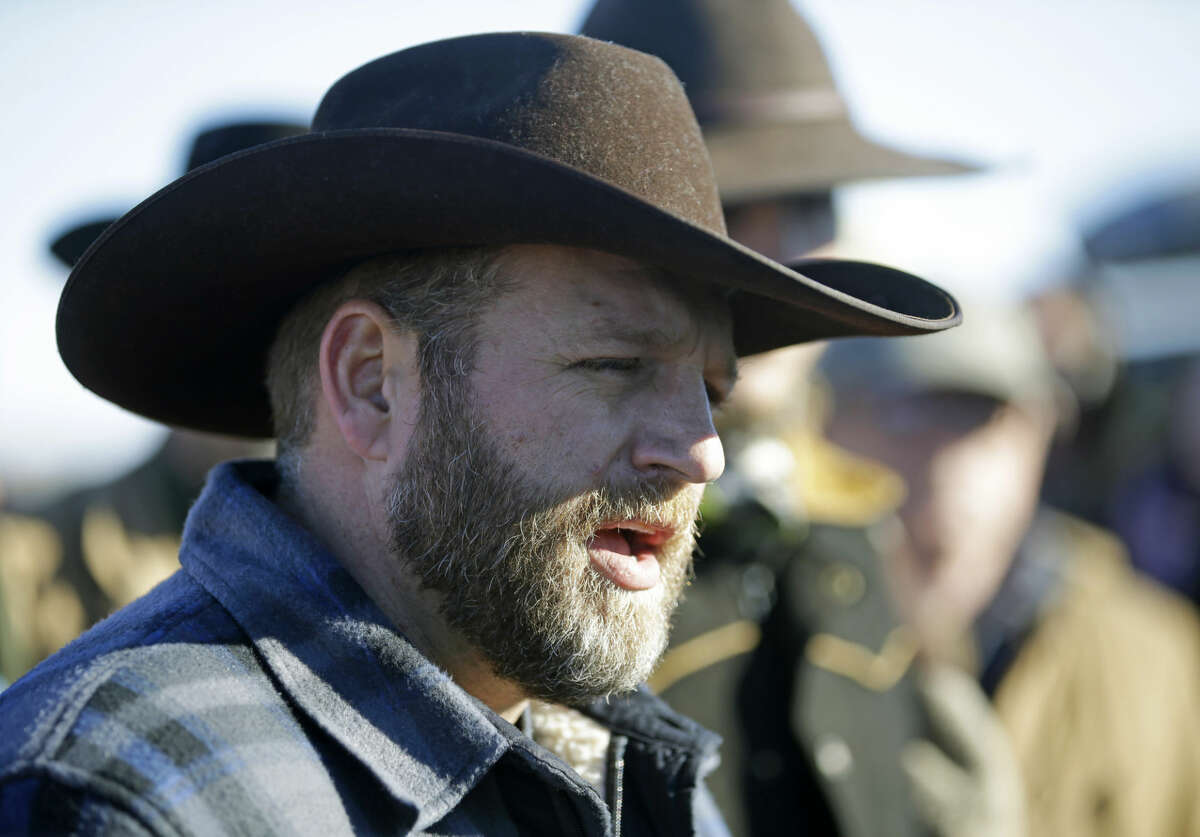 Ammon Bundy speaks with reporter at a news conference at Malheur National Wildlife Refuge Friday, Jan. 8, 2016, near Burns, Ore. Bundy, the leader of an armed group occupying the national wildlife refuge to protest federal land management policies, said Friday he and his followers are not ready to leave even though the sheriff and many locals say the group has overstayed their welcome. (AP Photo/Rick Bowmer)