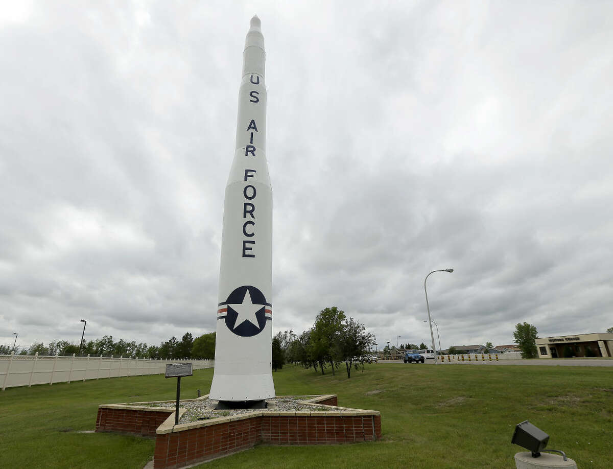 FILE - In this June 25, 2014, file photo, a retired Minuteman 1 missile stands at the main entrance to Minot Air Force Base, N.D. The Minuteman 1 was replaced by the Minuteman 3 by 1971 which now form the foundation of the US nuclear defense strategy. In the spring of 2014, as a team of experts was examining what ailed the U.S. nuclear force, the Air Force withheld from them the fact that it was simultaneously investigating damage to a nuclear-armed missile in its launch silo caused by three airmen. (AP Photo/Charlie Riedel)