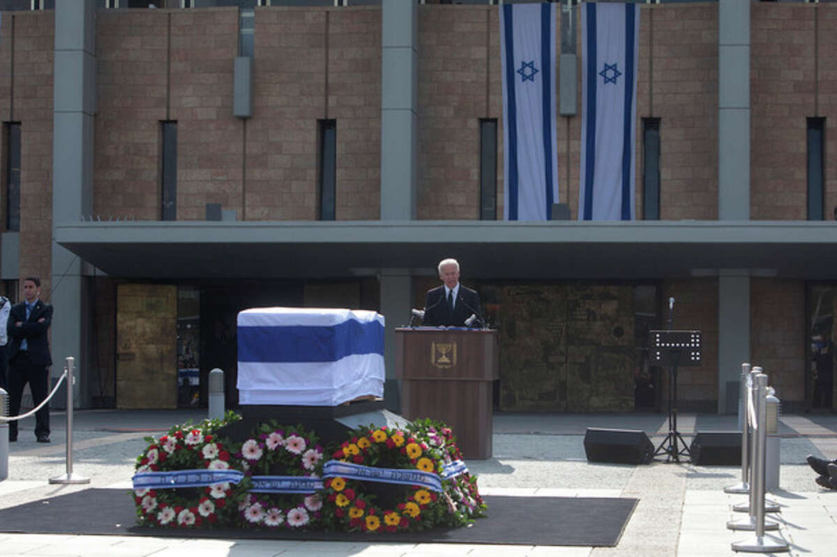 U.S. Vice President Joe Biden delivers a speech next to the coffin of late Israeli Prime Minister Ariel Sharon outside the Knesset, Israel's Parliament, in Jerusalem, Monday, Jan. 13, 2014. Israel is holding a state memorial ceremony for the former Prime Minister Ariel Sharon at the country's parliament building. Monday's official ceremony in the Knesset in Jerusalem will be followed by a private burial on the family's desert ranch in southern Israel. (AP Photo/Sebastian Scheiner)