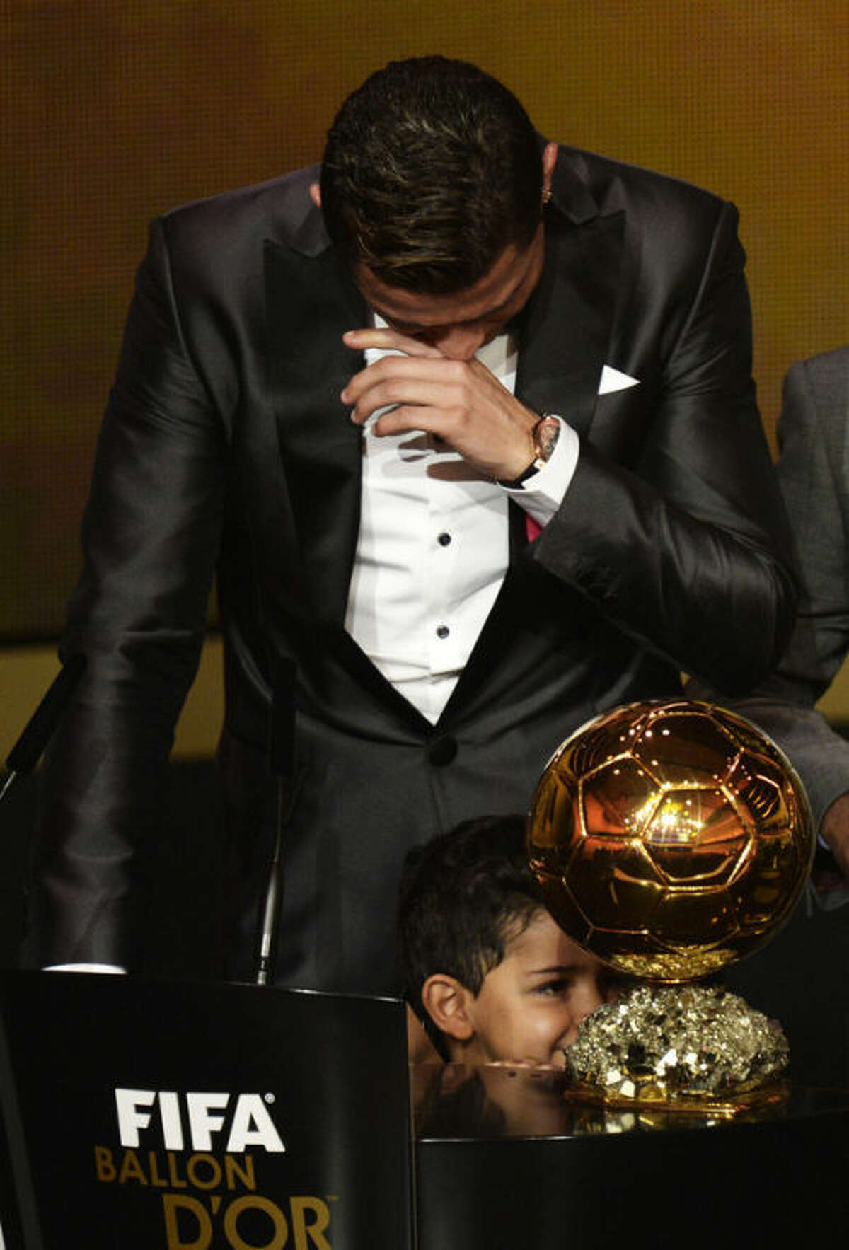 Cristiano Ronaldo of Portugal cries as he is awarded the prize for the FIFA Men's soccer player of the year 2013 at the FIFA Ballon d'Or 2013 gala at the Kongresshaus in Zurich, Switzerland, Monday, Jan. 13, 2014. (AP Photo, Keystone/Steffen Schmidt)
