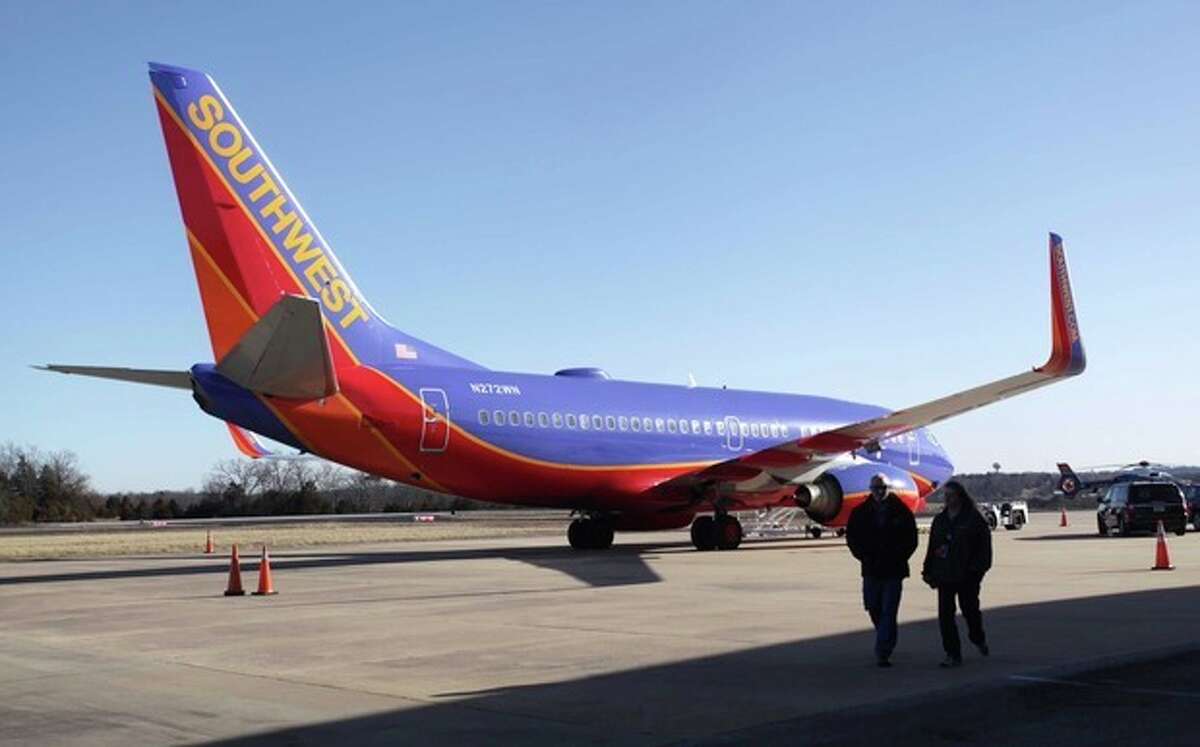Southwest Airlines Flight 4013 sits at the M. Graham Clark Downtown Airport in Hollister, Mo., Monday, Jan. 13, 2014. The plane was supposed to land at the nearby Branson Airport on Sunday evening, but instead landed at Clark Airport, also known as Taney County Airport, which has a much shorter runway than at Branson, about 7 miles away. (AP Photo/Springfield News-Leader, Valerie Mosley)