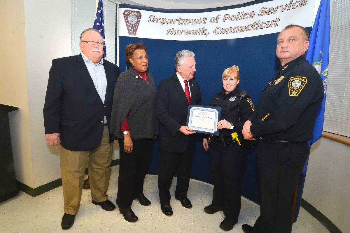 Hour Photo/Alex von Kleydorff Police Commissioners Charles Yost, Fran Collier Clemmons and Harry Rilling and Police Chief Tom Kulhawik present Officer Kimberly Prada a certificate for Officer of the Month at Norwalk Police Headquarters