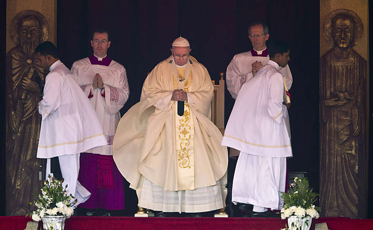 Pope Francis stands during Mass at Colombo's seafront Galle Face Green for the canonization ceremony of Joseph Vaz, Wednesday, Jan. 14, 2015. Francis declared Vaz a saint at the start of the service. The church considers Vaz a great model for today's faithful, ministering to the faithful of both Sri Lanka's ethnic groups and putting himself at great risk to spread the faith. (AP Photo/Saurabh Das)