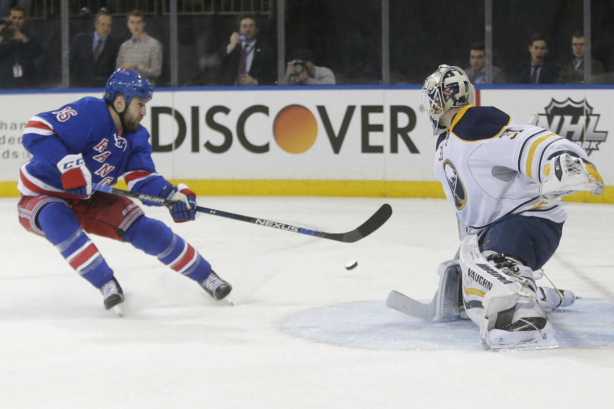 Buffalo Sabres goalie Chad Johnson (31) stops a shot on the goal by New York Rangers' Tanner Glass (15) during the second period of an NHL hockey game, Monday, Jan. 25, 2016, in New York. (AP Photo/Frank Franklin II)