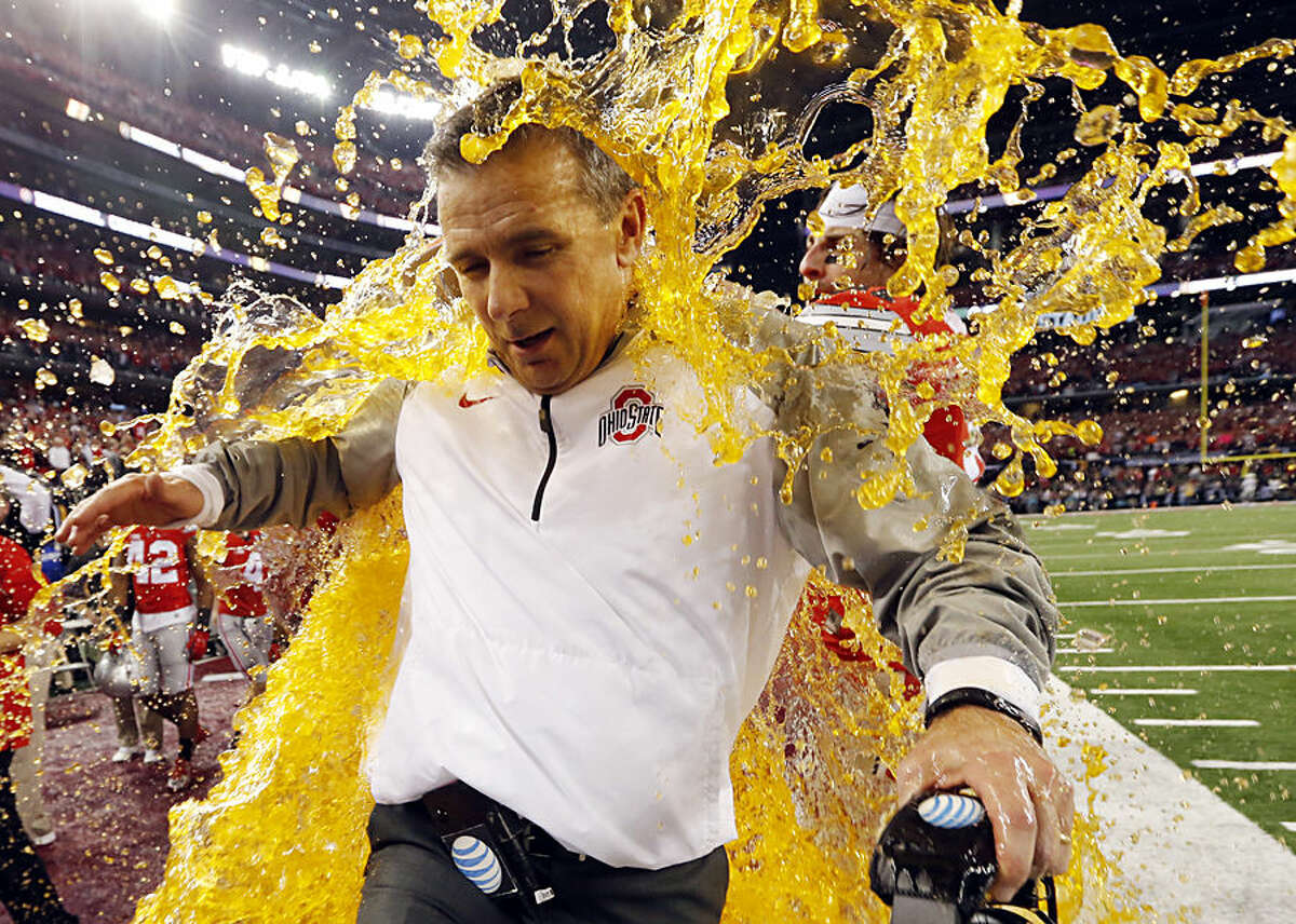 Ohio State head coach Urban Meyer is dunked during the NCAA college football playoff championship game against Oregon Monday, Jan. 12, 2015, in Arlington, Texas. Ohio State won 42-20. (AP Photo/Sharon Ellman, Pool)
