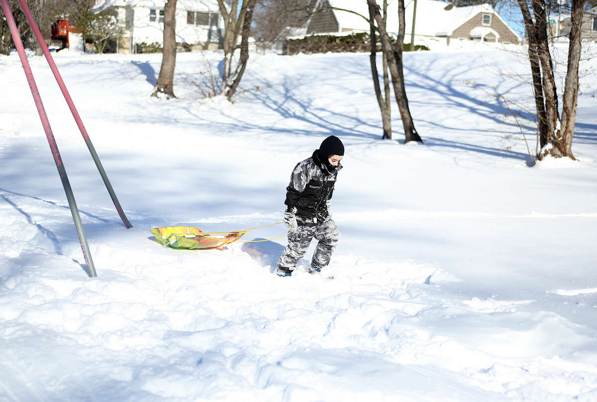 Gracyn James, 3, goes sledding at Kendall School after Winter Storm Jonas Sunday morning. Hour Photo / Danielle Calloway