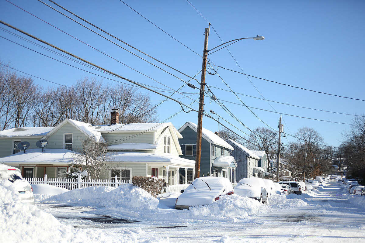 Snow covered cars line Third Street in Norwalk after Winter Storm Jonas Sunday morning. Hour Photo / Danielle Calloway