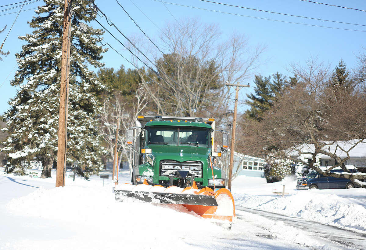 A city plow clears snow off of Pheasant Lane in Norwalk after Winter Storm Jonas Sunday morning. Hour Photo / Danielle Calloway