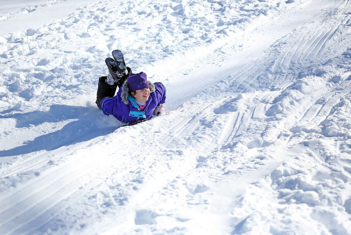 Samantha Pullia, 7, goes sledding at Kendall School in Norwalk after Winter Storm Jonas Sunday morning. Hour Photo / Danielle Calloway
