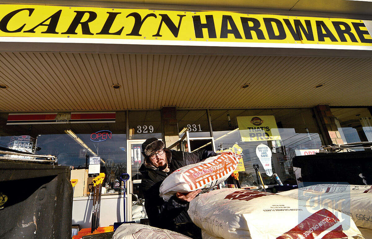 Hour photo / Erik Trautmann Cutomers at Carlyn Hardware, including Sophie Camie Assocuiates employee Robert Bergeron, stock up on supplies for the Snowstorm Jonas which approaches the Northeast Friday.