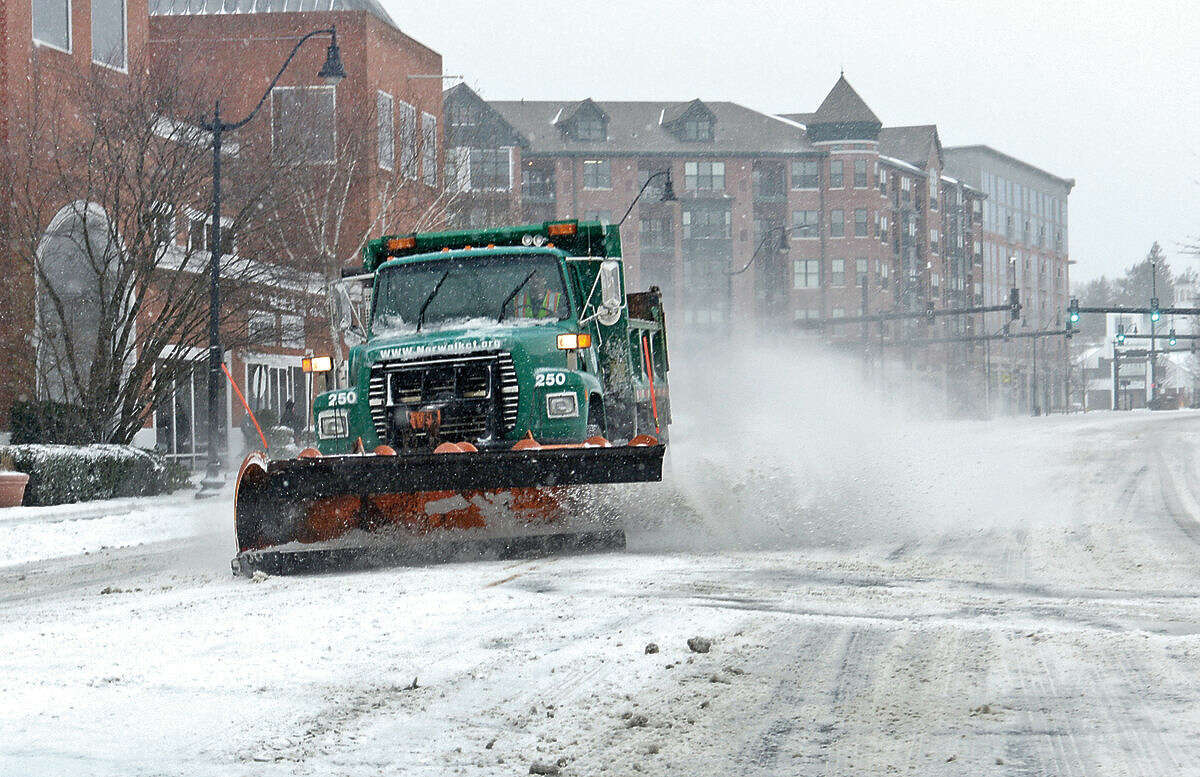Hour photo / Erik Trautmann DPW trucks in Norwalk cope with Snowstorm Jonas as it moves through the area Saturday.