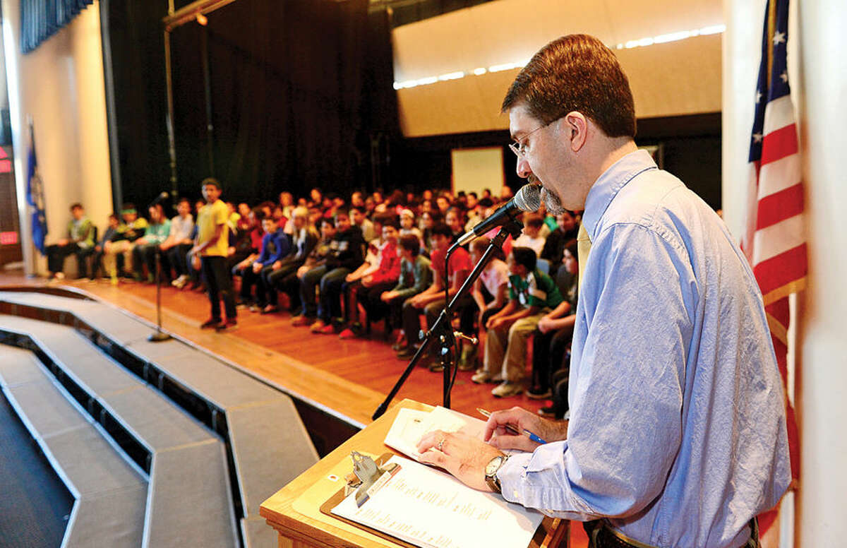 Hour photo / Erik Trautmann Nathan Hale Middle School teacher Dr Dave Gibson asks questions during the school's The National Geographic Geography Bee competition Thursday involving 24 students in grades 6, 7 and 8. The winner of the competition will go on to compete at the state level.